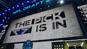 The Dallas Cowboys logo is projected on the video board during the NFL Draft at Lambeau Field. 