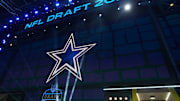 The Dallas Cowboys logo is projected on the video board during the NFL Draft at Lambeau Field.