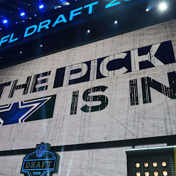 The Dallas Cowboys logo is projected on the video board during the NFL Draft at Lambeau Field. 