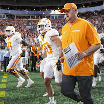 Sep 7, 2024; Charlotte, North Carolina, USA; Tennessee Volunteers head coach Josh Heupel runs onto the field with his team during the first quarter against the North Carolina State Wolfpack at the Dukes Mayo Classic at Bank of America Stadium. Mandatory Credit: Jim Dedmon-Imagn Images