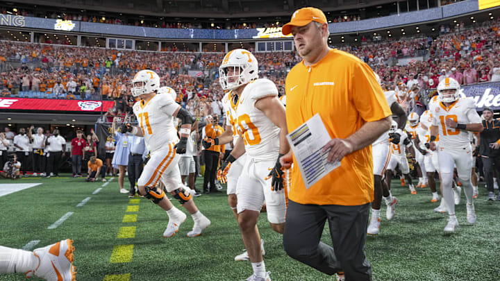 Sep 7, 2024; Charlotte, North Carolina, USA; Tennessee Volunteers head coach Josh Heupel runs onto the field with his team during the first quarter against the North Carolina State Wolfpack at the Dukes Mayo Classic at Bank of America Stadium. Mandatory Credit: Jim Dedmon-Imagn Images