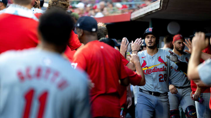 St. Louis Cardinals third baseman Nolan Arenado (28) is met in the dugout by teammates after hitting a solo home run in the seventh inning of the MLB game between the Cincinnati Reds and the St. Louis Cardinals at Great American Ball Park in Cincinnati on Tuesday, Aug. 13, 2024.