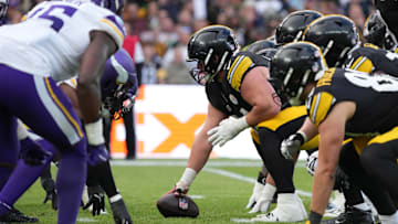 Sep 28, 2025; Dublin, Ireland; Helmets at the line of scrimmage as Pittsburgh Steelers center Zach Frazier (54) snaps the ball against the Minnesota Vikings in the fourth quarter during an NFL International Series game at Croke Park. Mandatory Credit: Kirby Lee-Imagn Images