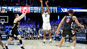 Xavier Musketeers guard Quincy Olivari (8) rises for a 3-point basket in the second half of the 91st Crosstown Shootout basketball game between the Cincinnati Bearcats and the Xavier Musketeers, Saturday, Dec. 9, 2023, at Cintas Center in Cincinnati. The Xavier Musketeers won, 84-79.
