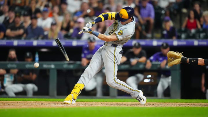 Jul 2, 2024; Denver, Colorado, USA; Milwaukee Brewers outfielder Christian Yelich (22) singles in the ninth inning against the Colorado Rockies at Coors Field. Mandatory Credit: Ron Chenoy-USA TODAY Sports