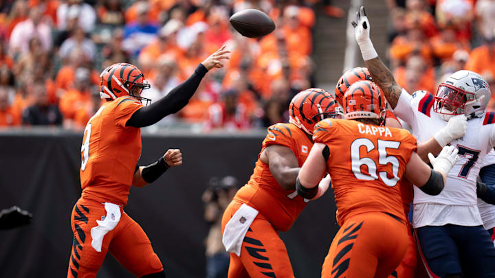 Cincinnati Bengals quarterback Joe Burrow (9) throws a pass as New England Patriots defensive tackle Trysten Hill (97) attempts to deflect it in the first quarter of the NFL game at Paycor Stadium in Cincinnati on Sunday, Sept. 8, 2024.