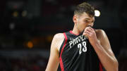 Jul 15, 2024; Las Vegas, NV, USA; Portland Trail Blazers center Donovan Clingan (23) wipes his face with his jersey during the first half against the Philadelphia 76ers at Thomas & Mack Center. Mandatory Credit: Lucas Peltier-USA TODAY Sports