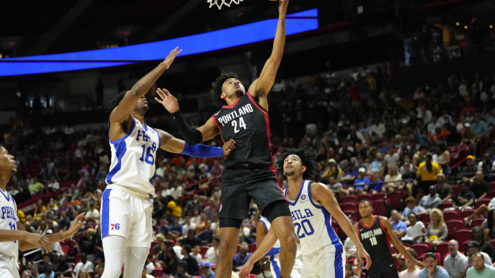 Jul 15, 2024; Las Vegas, NV, USA; Portland Trail Blazers forward Justin Minaya (24) attempts to score a layup against Philadelphia 76ers guard/forward Ricky Council IV (16) during the first half at Thomas & Mack Center. Mandatory Credit: Lucas Peltier-USA TODAY Sports