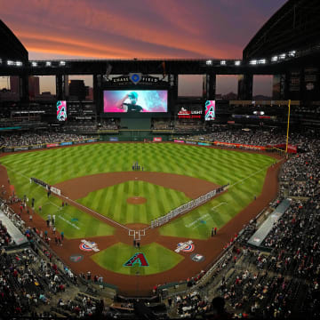 The sun sets as Diamondbacks players are introduced during Opening Day 2024 at Chase Field.