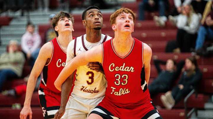 Ankeny's LaMarious Clark (3) and Cedar Falls' Leyton Wolf (33) look for the rebound after an Ankeny free throw on Thursday, Dec. 19, 2024, at Ankeny High School.