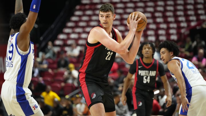 Jul 15, 2024; Las Vegas, NV, USA; Portland Trail Blazers center Donovan Clingan (23) controls the ball against the Philadelphia 76ers  during the first half at Thomas & Mack Center. Mandatory Credit: Lucas Peltier-USA TODAY Sports