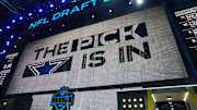 The Dallas Cowboys logo is projected on the video board during the NFL Draft at Lambeau Field. 