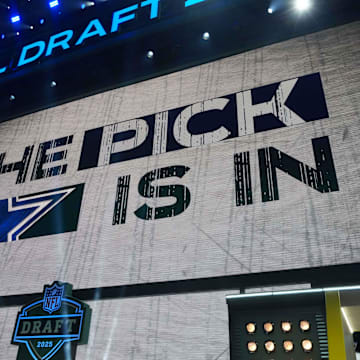 The Dallas Cowboys logo is projected on the video board during the NFL Draft at Lambeau Field. 