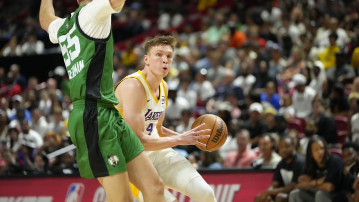 Jul 15, 2024; Las Vegas, NV, USA; Los Angeles Lakers forward Dalton Knecht (4) drives the ball against Boston Celtics guard Baylor Scheierman (55) during the first half at Thomas & Mack Center. Mandatory Credit: Lucas Peltier-USA TODAY Sports