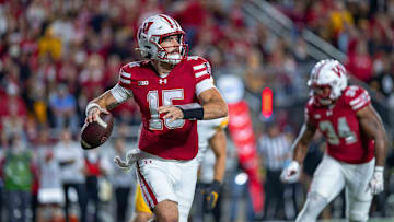 Oct 11, 2025; Madison, Wisconsin, USA; Wisconsin Badgers quarterback Hunter Simmons (15) looks downfield to pass against the Iowa Hawkeyes at Camp Randall Stadium. Mandatory Credit: Ross Harried-Imagn Images