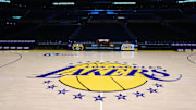 The Los Angeles Lakers logo at midcourt at Crypto.com Arena. 
