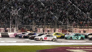 Feb 25, 2024; Hampton, Georgia, USA; NASCAR Cup Series driver Daniel Suarez (99) (near wall) beats NASCAR Cup Series driver Ryan Blaney (12) to the line to win the Ambetter Health 400 at Atlanta Motor Speedway.