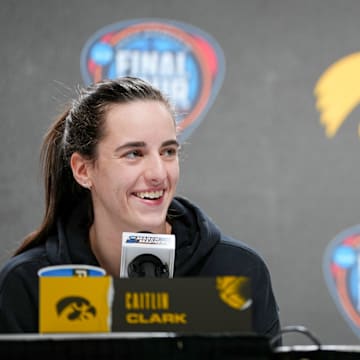 Iowa Hawkeyes guard Caitlin Clark (22) and guard Kate Martin (20) take questions