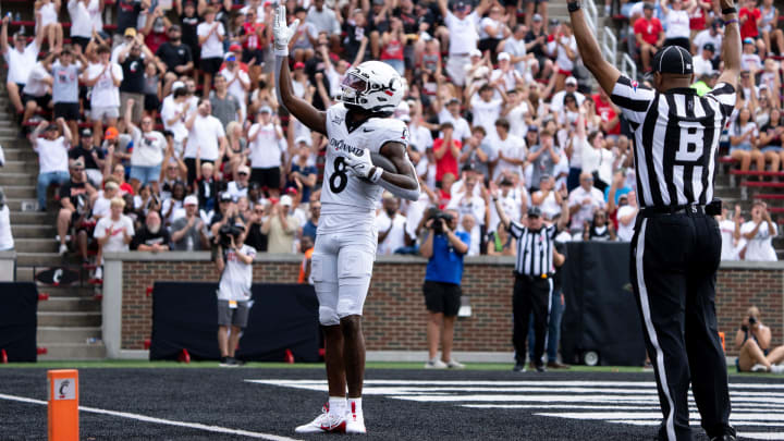 Cincinnati Bearcats wide receiver Xzavier Henderson (8) gestures after scoring a touchdown in the first quarter of the College Football game between the Cincinnati Bearcats and the Towson Tigers at Nippert Stadium in Cincinnati on Saturday, Aug. 31, 2024.