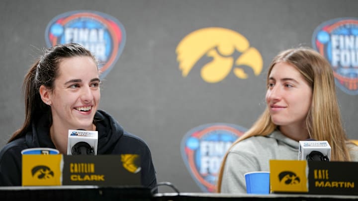 Iowa Hawkeyes guard Caitlin Clark (22) and guard Kate Martin (20) take questions