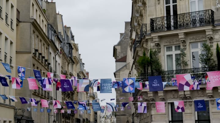 Jul 26, 2024; Paris, FRANCE; Flags hang between buildings ahead of the Opening Ceremony for the Paris 2024 Olympic Summer Games.