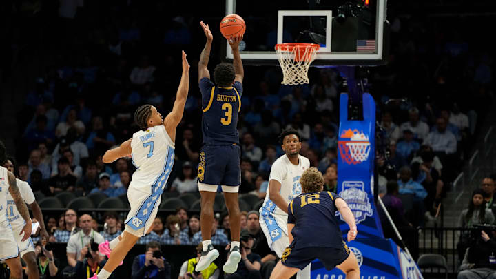 Mar 12, 2025; Charlotte, NC, USA; Notre Dame Fighting Irish guard Markus Burton (3) shoots as North Carolina Tar Heels guard Seth Trimble (7) defends in the first half at Spectrum Center. Mandatory Credit: Bob Donnan-Imagn Images
