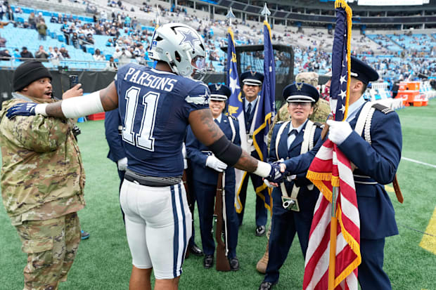Dallas Cowboys linebacker Micah Parsons greets the flag bearers before a game against the Carolina Panthers. 