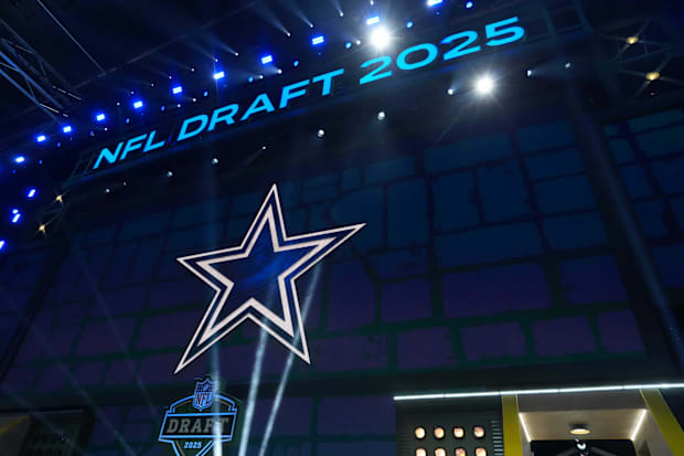 The Dallas Cowboys logo is projected on the video board during the NFL Draft at Lambeau Field. 