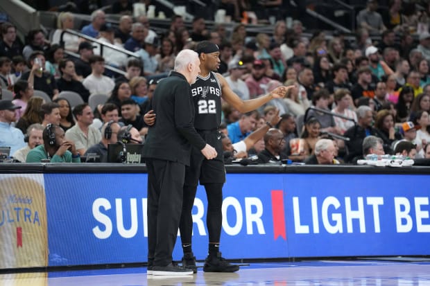 San Antonio Spurs head coach Gregg Popovich talks with Malaki Branham (22) in the first half against the Phoenix Suns.