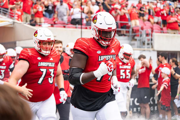 Louisville Cardinals take the field ahead of their game against the Austin Peay Governors