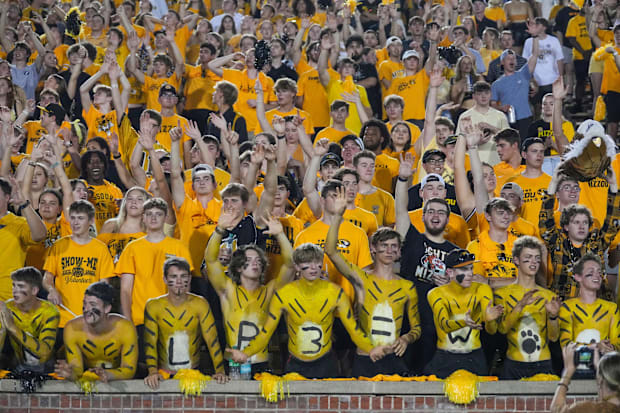 Missouri Tigers students and fans reach for t-shirts being tossed into the crowd during the second half of the game against.