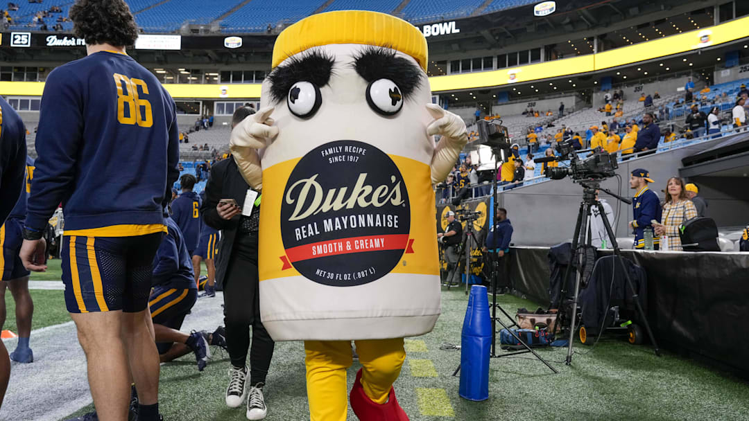 Dec 27, 2023; Charlotte, NC, USA; Official Mayo Bowl mascot during pregame warm ups between the North Carolina Tar Heels and the West Virginia Mountaineers  at Bank of America Stadium. Mandatory Credit: Jim Dedmon-Imagn Images