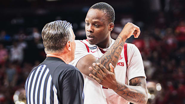 Johnell Davis (1) speaks to the official 