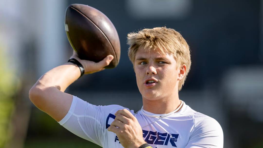 Isaac Wilson tosses the ball back and forth with a teammate before a seven-on-seven tourney game in Layton on Friday, June 9, 2023. Wilson, a younger brother of BYU star Zach Wilson, recently announced he will be playing his college football for the rival Utes. Isaac Wilson tosses the ball back and forth with a teammate before a seven-on-seven tourney game in Layton on Friday, June 9, 2023. Wilson, a younger brother of BYU star Zach Wilson, recently announced he will be playing his college football for the rival Utes.