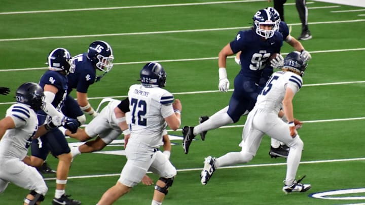 Smithson Valley's Hudson Woods returns a fumble during the fourth quarter of the Class 5A Division I finals on Friday at AT&T Stadium in Arlington. 