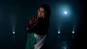 Former Arkansas gymnast Sirena Linton poses for a WWE promotional shoot for A&E's "Legends & Future Greats" wrapped in the Mexican flag. 