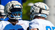 Detroit Lions defensive tackle DJ Reader (98), left, talks to defensive end Aidan Hutchinson (97).