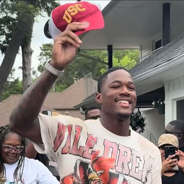 Ethan "Boobie" Feaster of Texas' Desoto High flashes a big smile as he holds up a USC cap, after to committing to the Trojans
