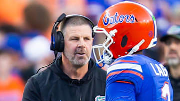 Florida Gators head coach Billy Napier talks with Florida Gators quarterback DJ Lagway (2) during the first half at Ben Hill Griffin Stadium in Gainesville, FL on Saturday, November 16, 2024. [Doug Engle/Gainesville Sun]
