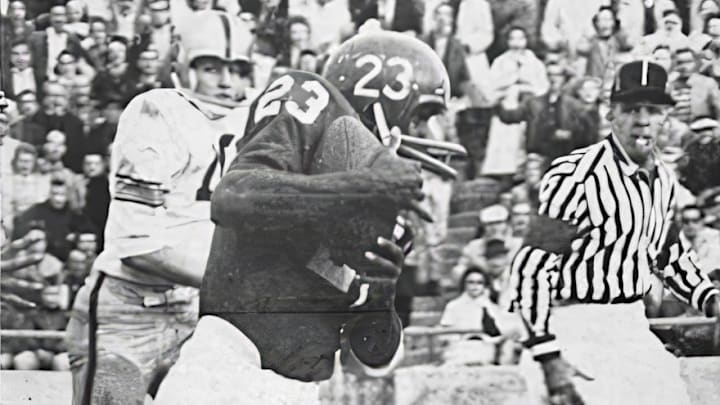 Bennie Dillard cradles the ball en route to Nebraska's winning touchdown against Army in 1960. Bennie Dillard cradles the ball en route to Nebraska's winning touchdown against Army in 1960.