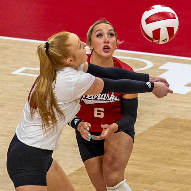 Nebraska libero Olivia Mauch passes while DS Laney Choboy watches against Oregon.
