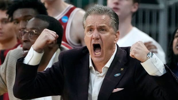 University of Arkansas coach John Calipari egging his players on against the Kansas Jayhawks in the first round of the NCAA 