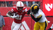 Nebraska running back Emmett Johnson stiff-arms an Iowa defender.