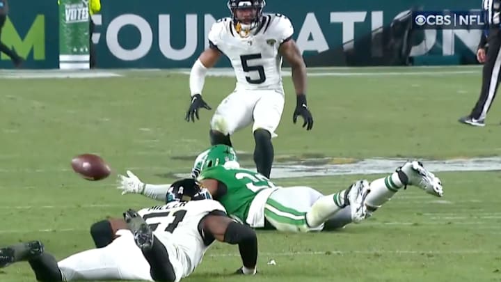 Philadelphia Eagles RB Saquon Barkley loses the football after being tripped by Jacksonville Jaguars LB Ventrell Miller.