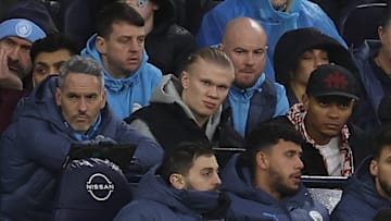 Erling Haaland (centre) watched Manchester City's defeat to Liverpool from the substitute's bench