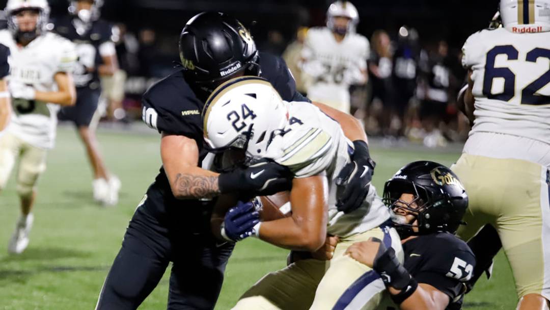 Gateway's Jakson Smith, left, and Julius Clark, right, haul down Kiski Area's Ashton Taylor during a 31-10 Gators' win Week 1 at Antimarino Stadium in Monroeville.