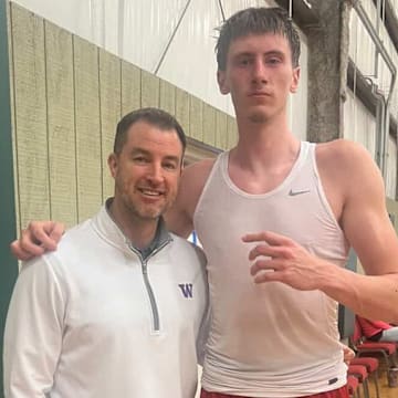 UW coach Danny Sprinkle meets with transfer Christian Nitu.
