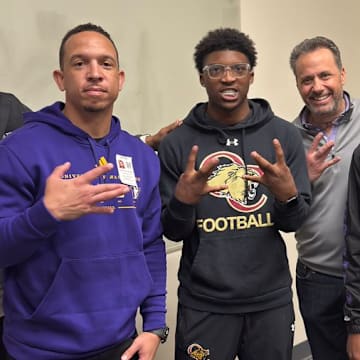 Davon Benjamin, center spends time with UW coaches Taylor Mays, Ryan Walters, Jedd Fisch and John Richardson. 