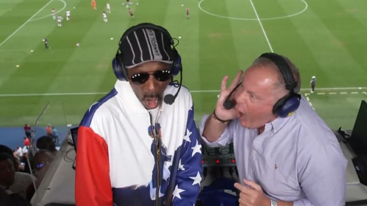 Snoop Dogg tries out a "GOL" call with Telemundo host Andres Cantor