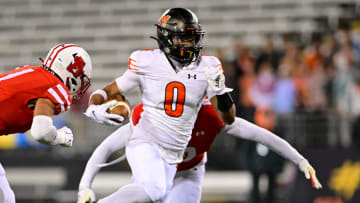 Nick Abrams of McDonogh (0) runs for extra yardage in the 2023 MIAA A Conference championship game against Archbishop Spalding.